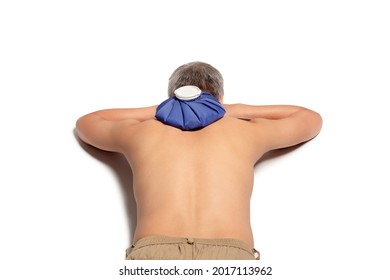 Man Lying Face Down Using Ice Pack Bag Compress To The Nape, Relieving Pain. Isolated On White Background.