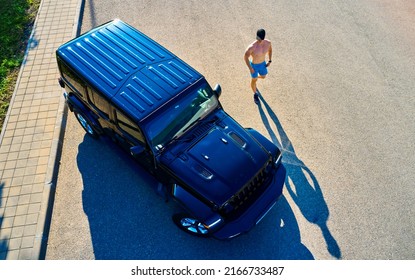 Man Is Lying On The Roof Of A Car