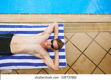 Man Lying On Towel By Pool, View From Above