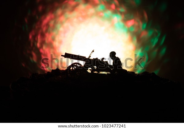 Man with Machine gun at night, fire explosion
background or Military silhouettes fighting scene on war fog sky
background, World War Soldiers Silhouettes Below Cloudy Skyline At
night. Attack scene.