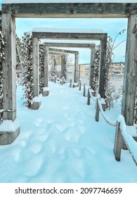 Man made frame in frame architecture through a walking path with fresh snow