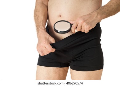 Man with magnifying glass looking into his boxer underwear