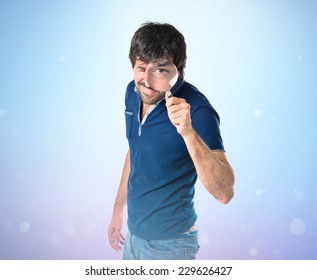 Man With Magnifying Glass Over Blue Background