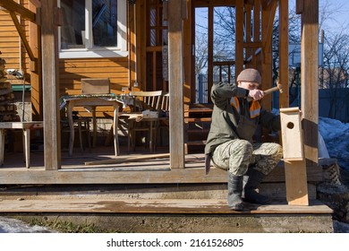 A Man Makes A Bird House In His Backyard.