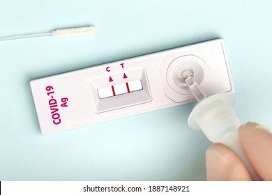 Man makes a covid-19 antigen pcr express test macro. The test showed a positive result - Shutterstock ID 1887148921