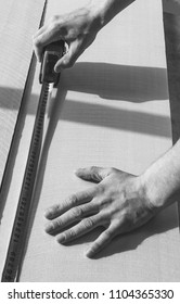 A Man Makes A Marking Tape On A Sheet Of Sound Proof And Heat Insulating Material, Black And White Photo