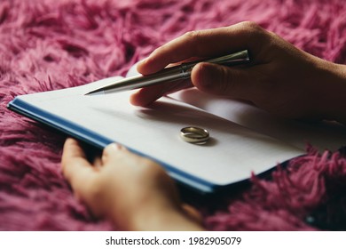 A man makes a note in a notebook