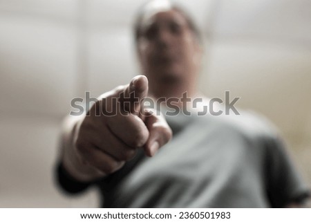A man makes a pointing gesture. Concept of violence.