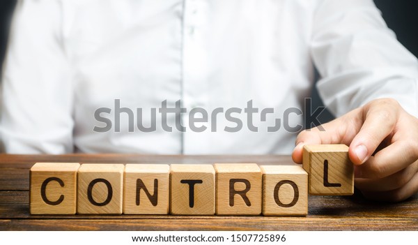 Man makes up the word Controls. Business and\
process management concept. Control Monitoring compliance with\
rules and responsibilities. Manage staff and workers. Self\
discipline