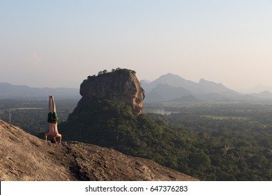 Man Makes Yoga Headstand Sirsasana On Sigirya Rock - Sri Lanka