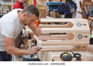 A Man Is Making Bespoke Furniture In A Woodwork Workshop Showing The Construction Process