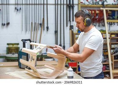 A Man Is Making Bespoke Furniture In A Woodwork Workshop Showing The Construction Process