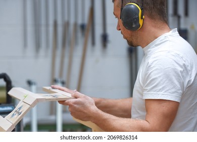 A Man Is Making Bespoke Furniture In A Woodwork Workshop Showing The Construction Process