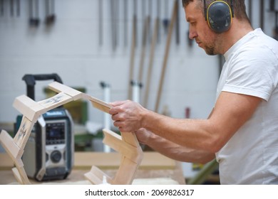 A Man Is Making Bespoke Furniture In A Woodwork Workshop Showing The Construction Process