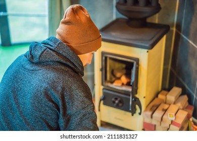 Man Making Fire In The Fireplace. Rest In The Mountains In Glamping. Cozy Fireplace In A Mountain House