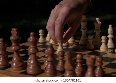 Man Making First Move In A Chees Game, Pawn Two Steps Ahead Seen From Blacks