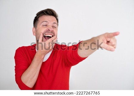 Man making fun of something laughing and pointing 