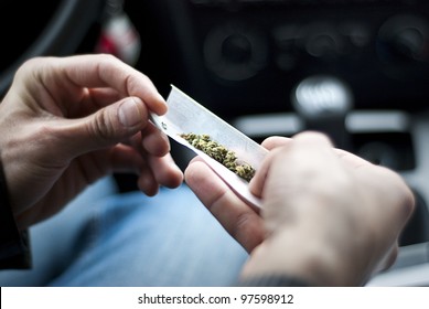 Man Making Joint And A Stash Of Marijuana Narcotics In The Car