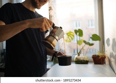 Man Making Morning Coffee In Moka Espresso Pot. Flavorful Coffee At Home Kitchen. Male Pouring Coffee In A Cup. Guy Morning Cozy Ritual. Breakfast Lighter Roast Blend. Home Leisure Fika At Holidays