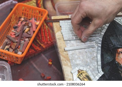 Man making mosaic. Process of making mosaic. 