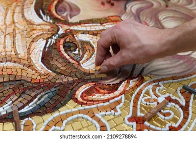Man making mosaic. Process of making mosaic.