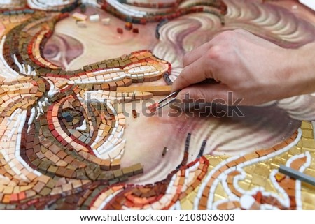 Man making mosaic. Process of making mosaic. 