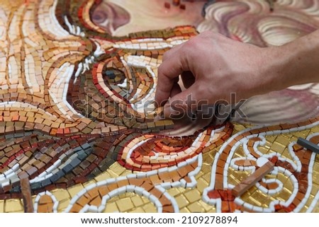 Man making mosaic. Process of making mosaic.