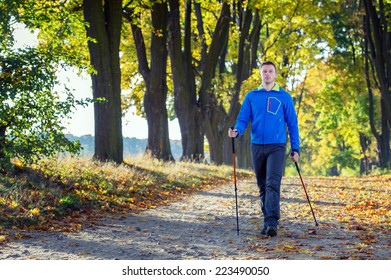 Man Making Nordic Walking In The Park