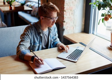 Man making notes in the textbook. - Powered by Shutterstock