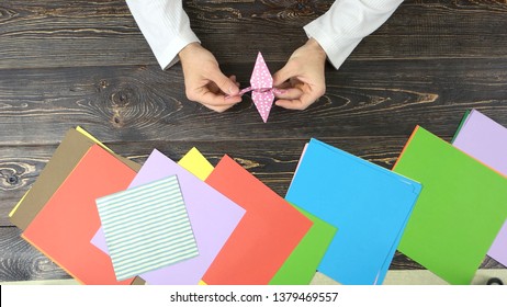 Man Making Orizuru Figurine, Top View. Traditional Japanese Design Of Paper Crane. Origami Crafting Workshop.