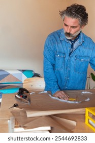 A man making a pattern for a clothing design