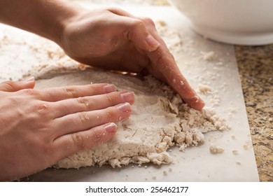 Man making pie crust from scratch - macro shot forming dough