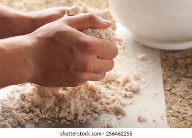 Man making pie crust from scratch - kneading pie crust dough