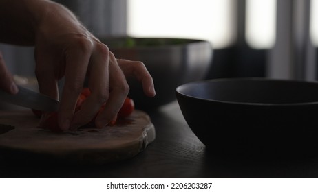 Man Making Salad In Black Bowl, Cut Tomatoes, Wide Photo