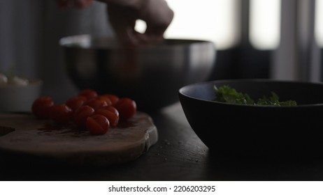 Man Making Salad In Black Bowl, Add Kale, Wide Photo