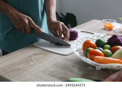 Man Making Salad, Cut The Purple Cabbage With Knife On Cutting Board - Powered by Shutterstock