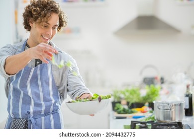 Man Making Salad In Kitchen