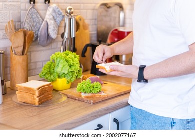 Man Making Sandwich On The Kitchen Copy Space