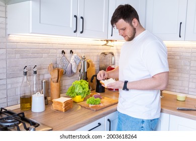 Man Making Sandwich On The Kitchen Copy Space