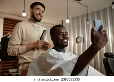 Man making selfie portrait with his barber - Powered by Shutterstock