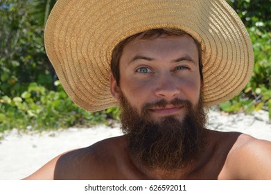 Man Making Silly Face With Straw Hat And Beard