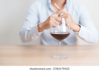 man making stop hand gesture to refuse a glass of Wine, Healthy man say no to alcohol drink, stop alcoholism and addiction concept. Responsible man reject a drink before driving and quit booze