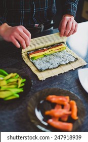 A Man Is Making Sushi At Home