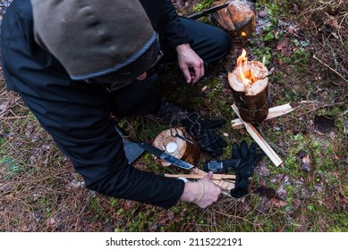 Man making Swedish Fire Log. Burning a Swedish candle, torch in winter evening.