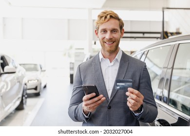 Man Male Customer Client Buyer In Classic Suit Choose Auto Want Buy New Car Automobile Use Credit Bank Card Speak By Mobile Cell Phone In Showroom Salon Dealership Store Motor Show Indoor Sale Concept