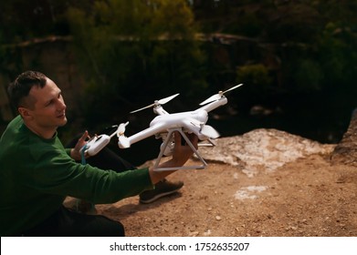 Man Manages Quadrocopters. Remote Control For The Drone In The Hands Of Men