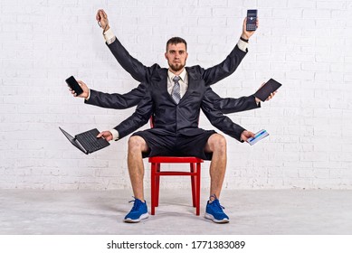 A man with many hands sits on a chair in a jacket and shorts. Multitasking. Business man, workaholic. - Shutterstock ID 1771383089