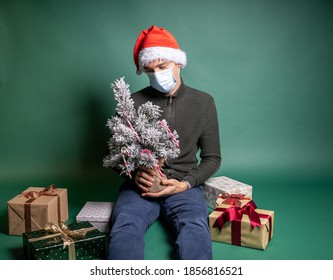 man with many wrapped gifts on green background - Powered by Shutterstock