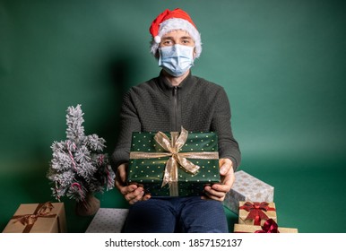 man with many wrapped gifts on green background - Powered by Shutterstock