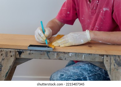 Man Marking The Line On Wood With Pencil, Selective Focus On Pencil. Home Refurbishment Do It Yourself Project. 